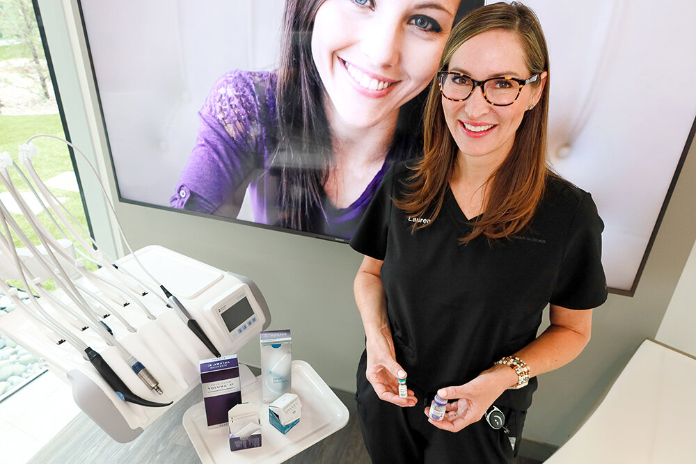 Nurse injector Lauren Helmuth displays new spa products at Innovative Dental.